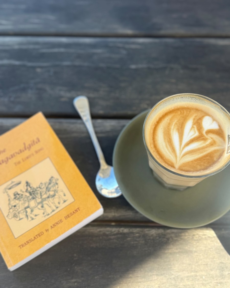 A coffee and a book on a table